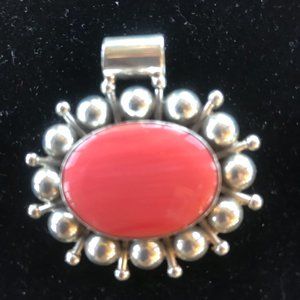 Large sterling silver pendant with  coral stone in center,